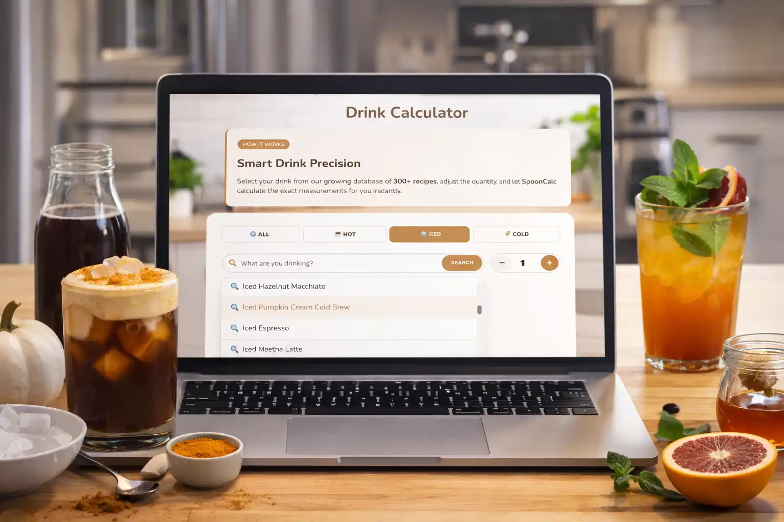 Laptop showing SpoonCalc drink calculator beside homemade iced drinks on kitchen counter.